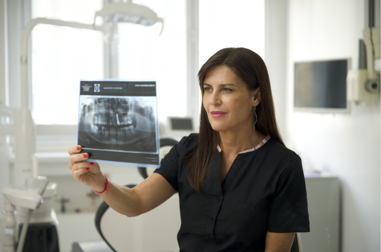 Dentist Maria Marta looking at a dental X-ray