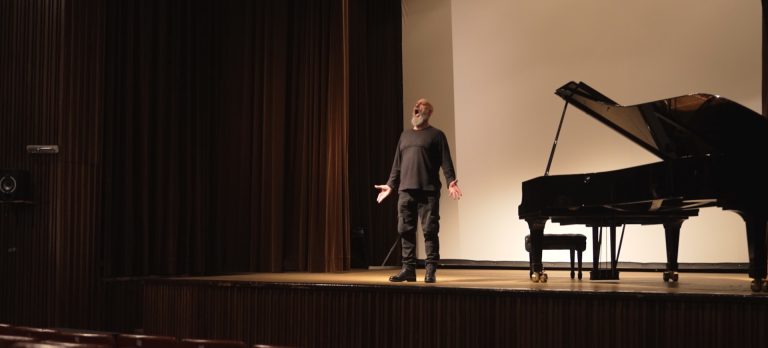 Opera singer survived war: Dario Volonte on stage singing Aurora next to a piano, while we filmed